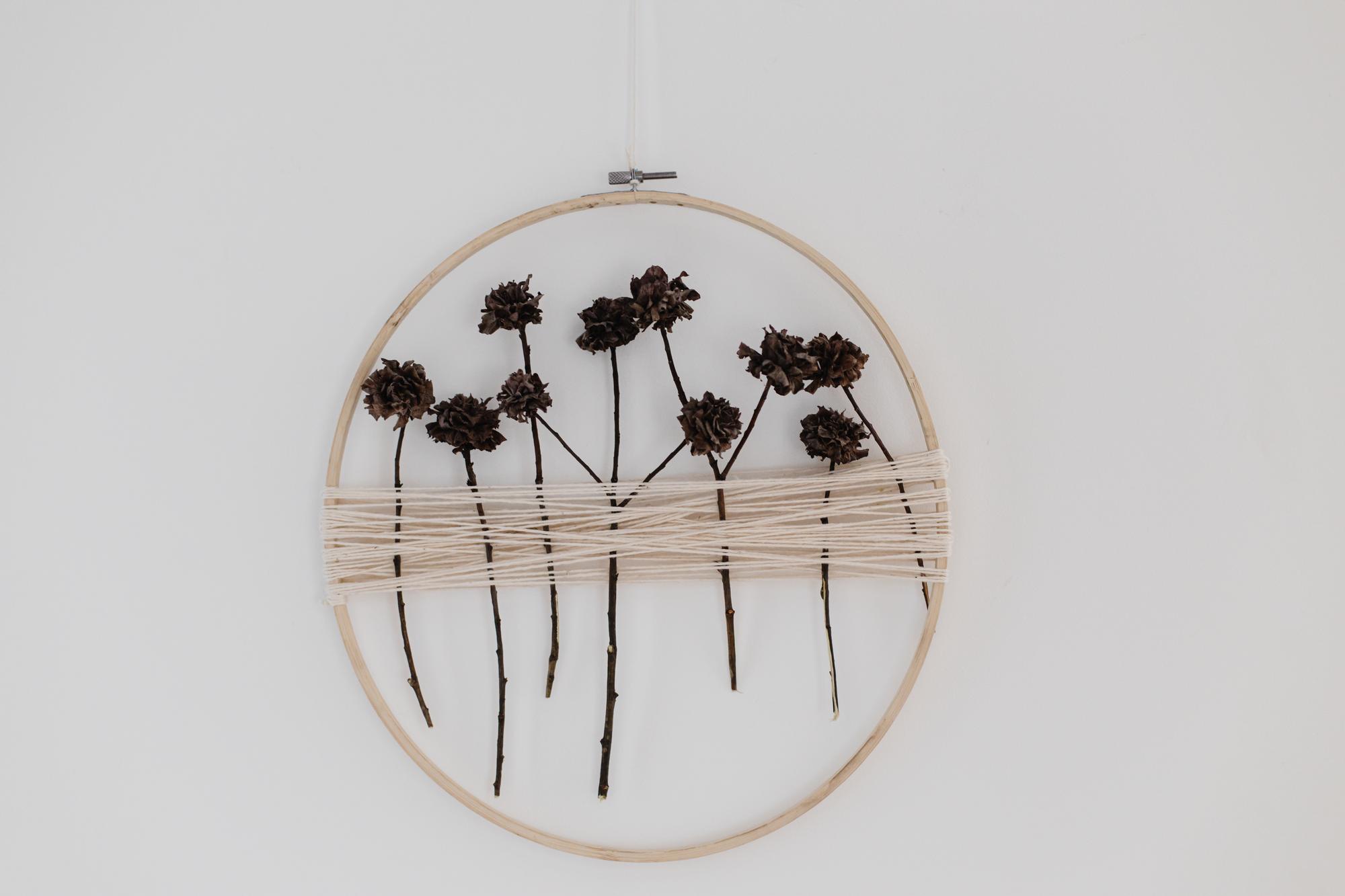 Embroidered floral hoop on dark linen